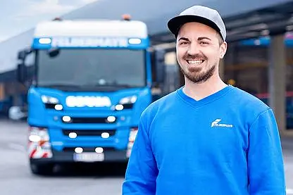 © andUP photo / social media Junger Fahrer vor seinem Lkw